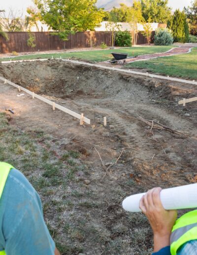 male-and-female-workers-overlooking-pool-construct